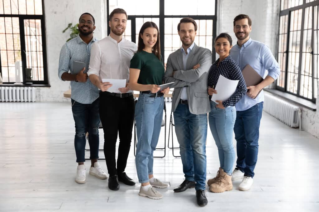 A team of solar professionals standing and smiling