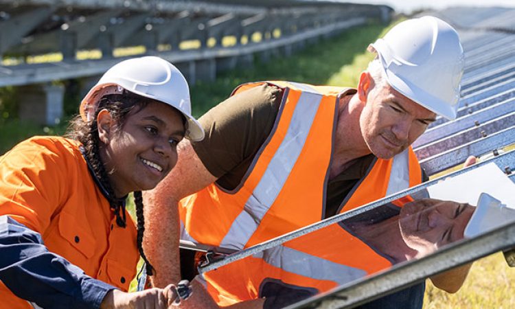 Two tradies working together on a Solar Farm installation